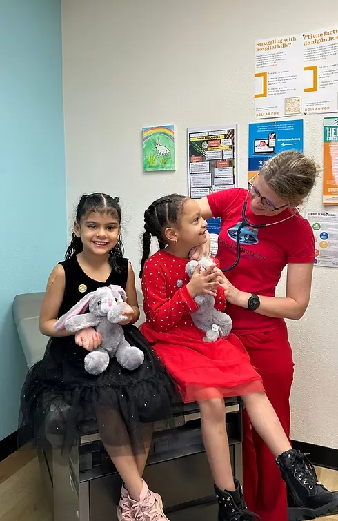 Girls with stuffed animals at Lirios Pediatrics